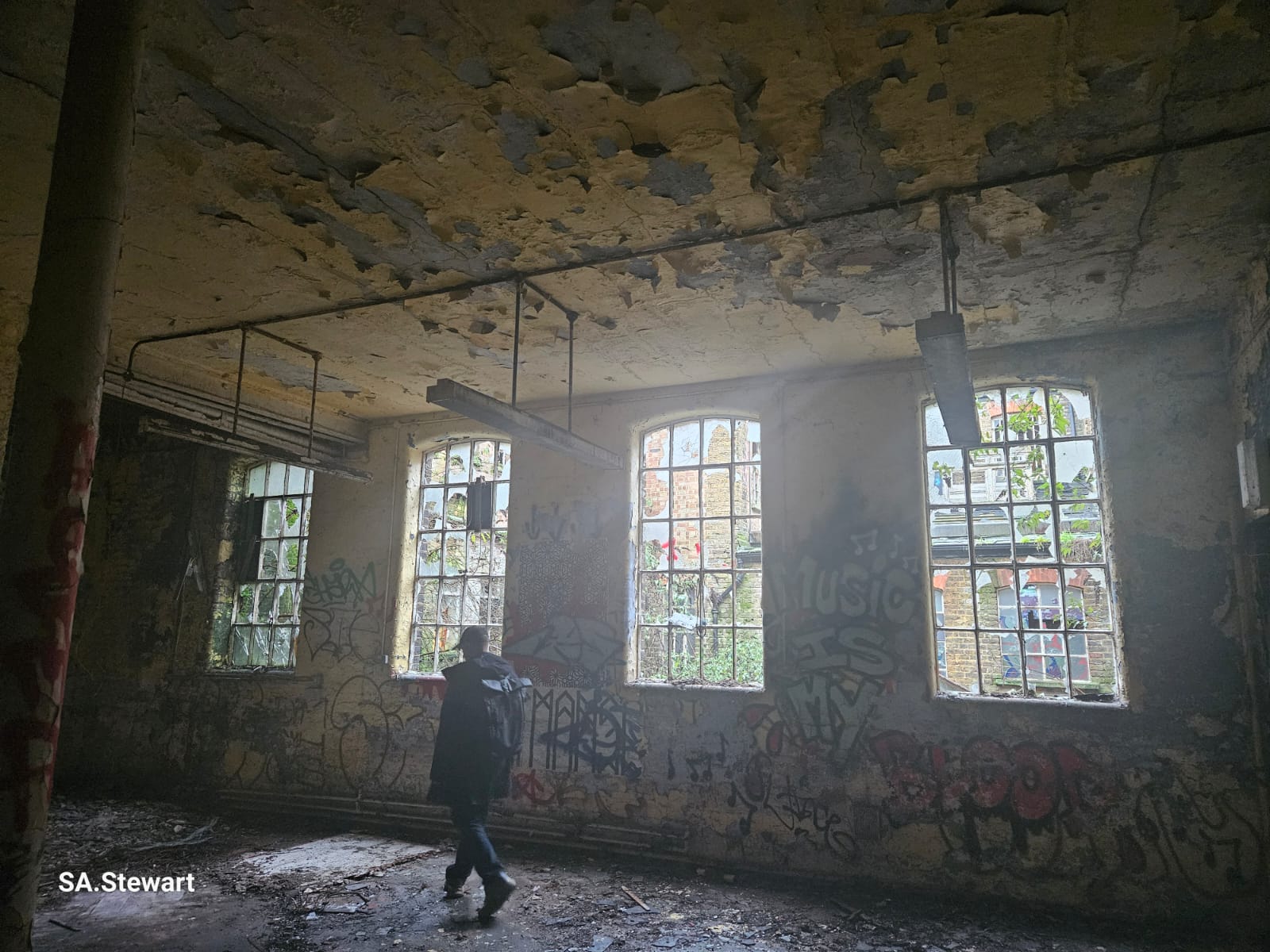 The main hall interior, with tall arched windows and suspended industrial light fixtures