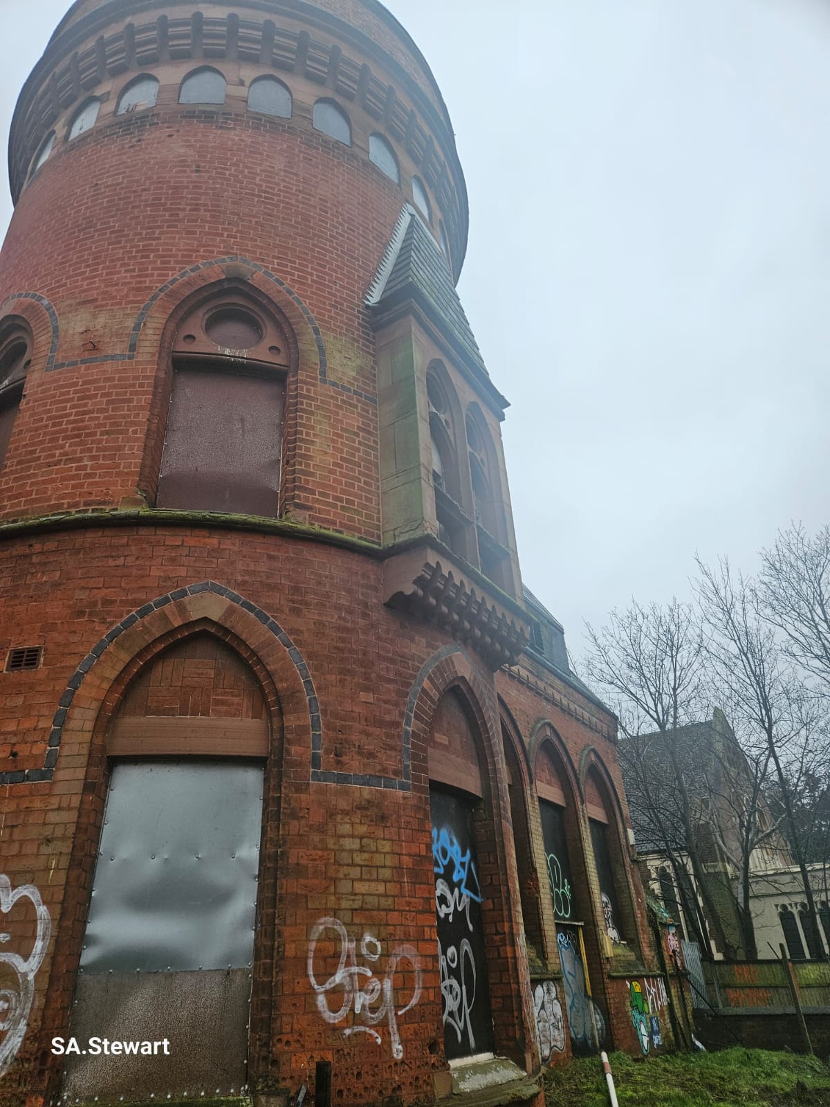 The Victorian Playtower exterior, with its distinctive round brick tower and arched openings