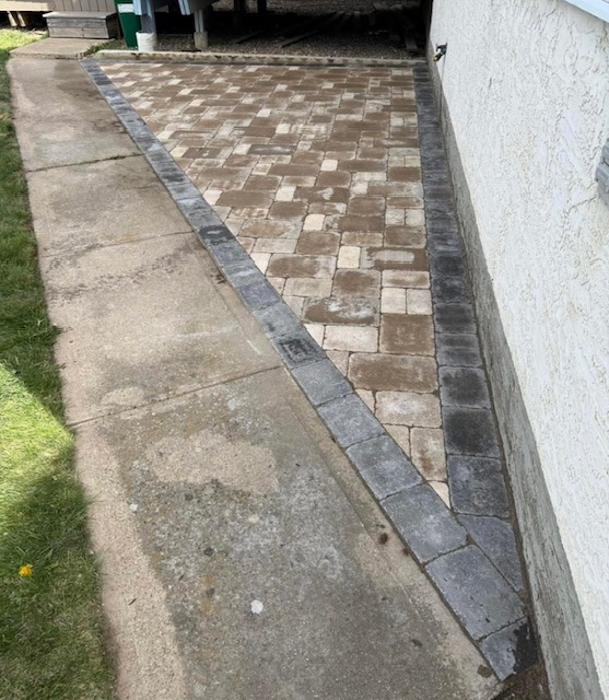 Paving stone replacement area beside a concrete walkway