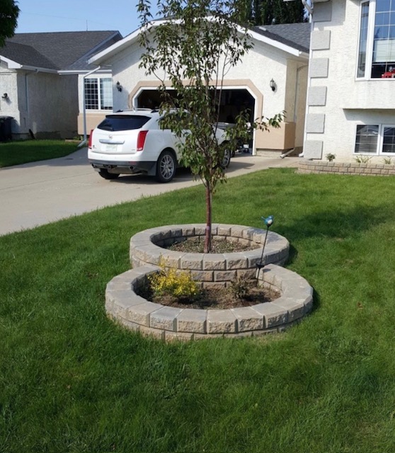 Circular spiral retaining wall planting bed in front yard