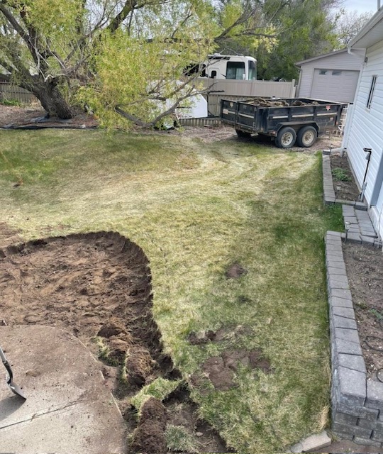 Backyard repair and preparation area with hardscape edging