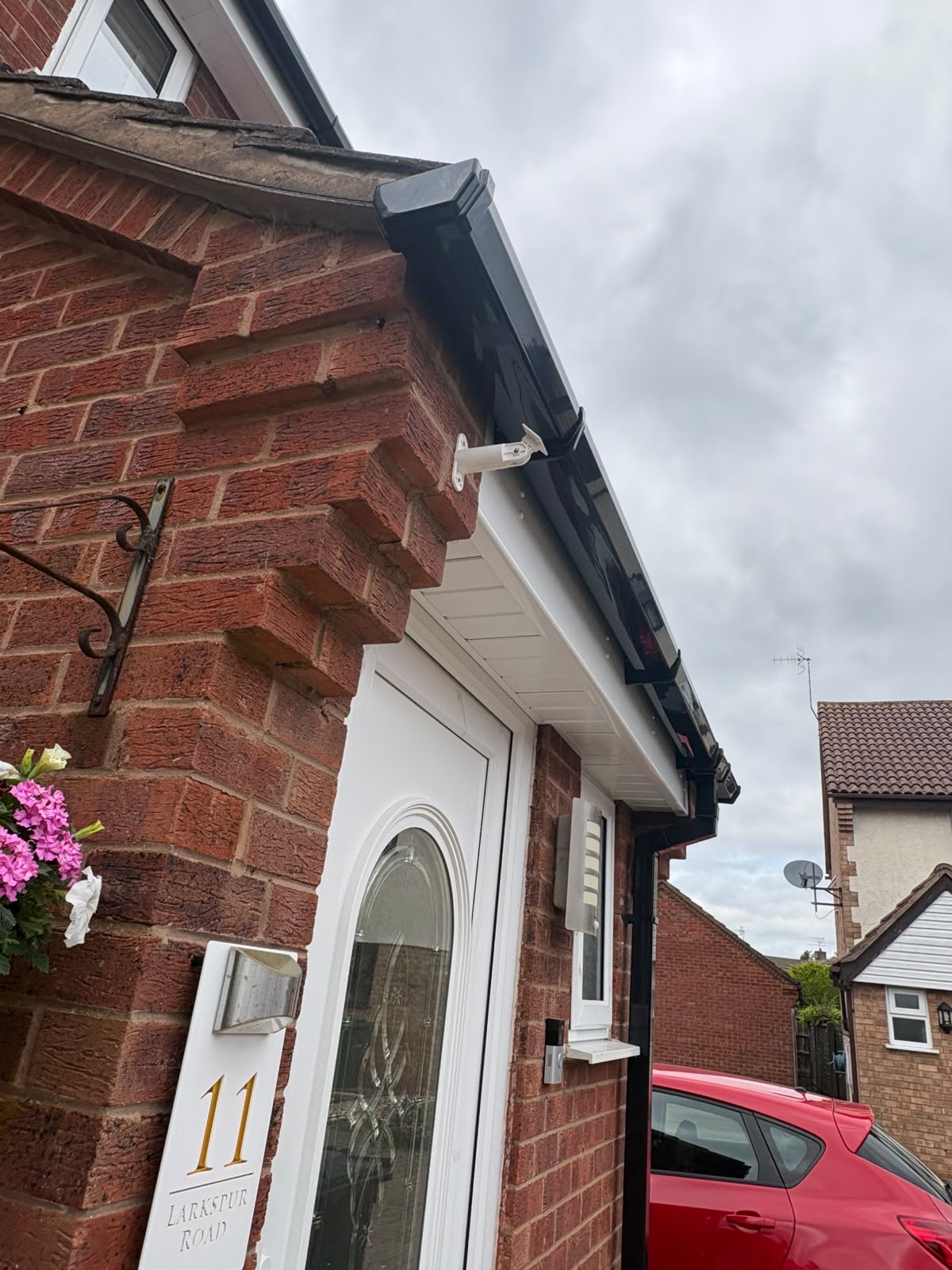 Fascias & soffits Worcester — black guttering with white UPVC fascias on brick corner