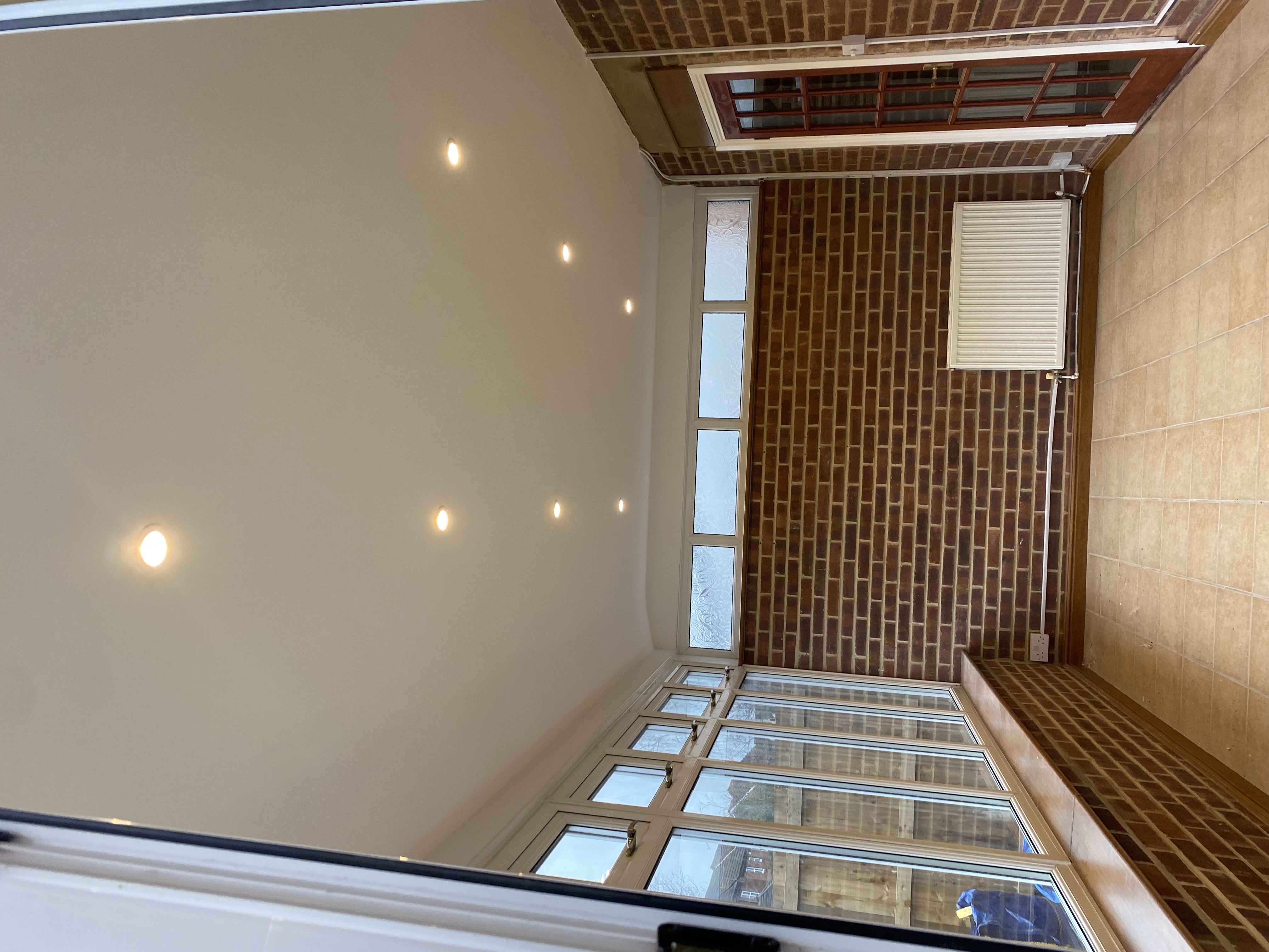 Conservatory interior with exposed brickwork and tiled floor