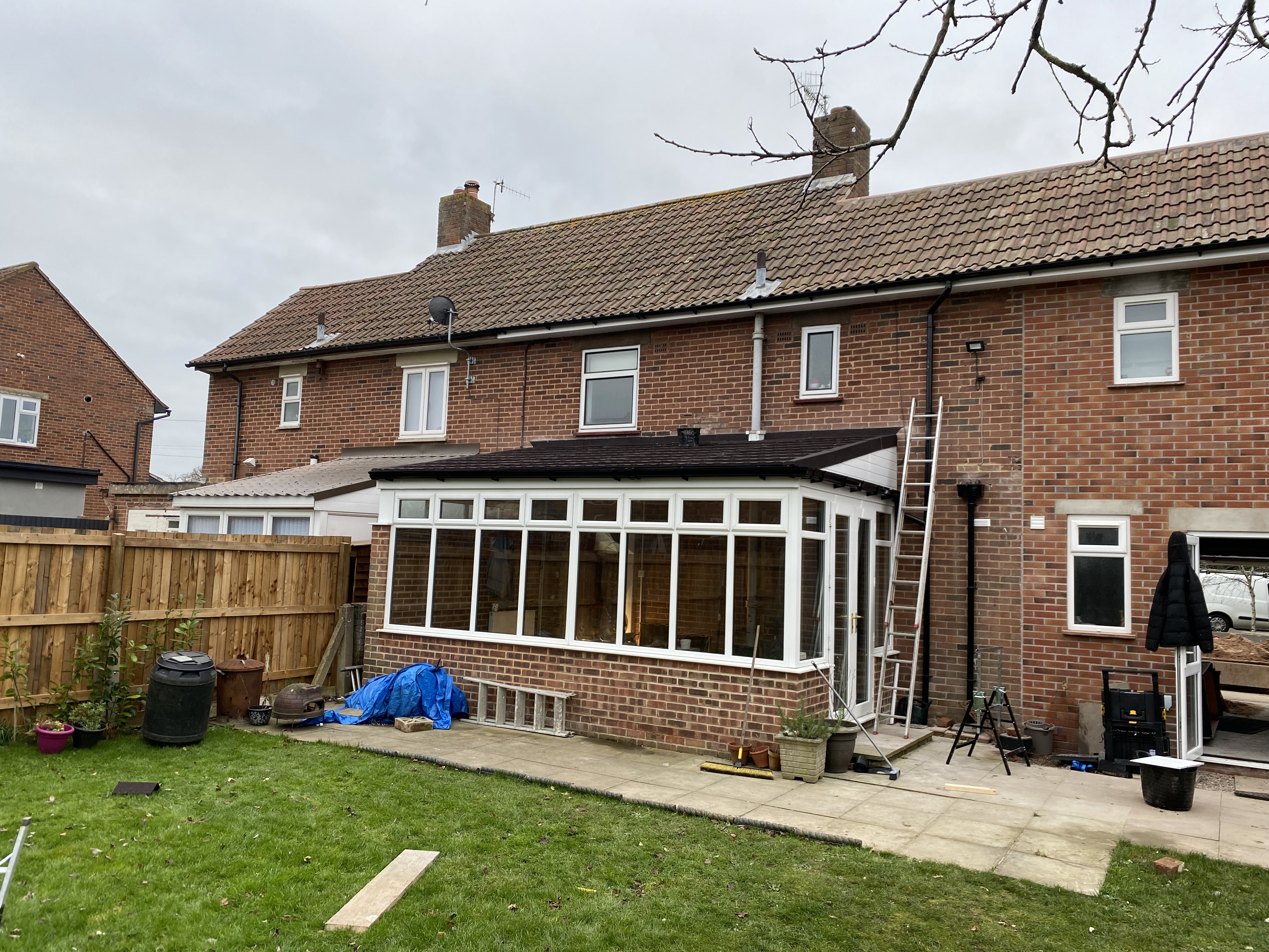 Semi-detached house with new dark tiled conservatory warm roof