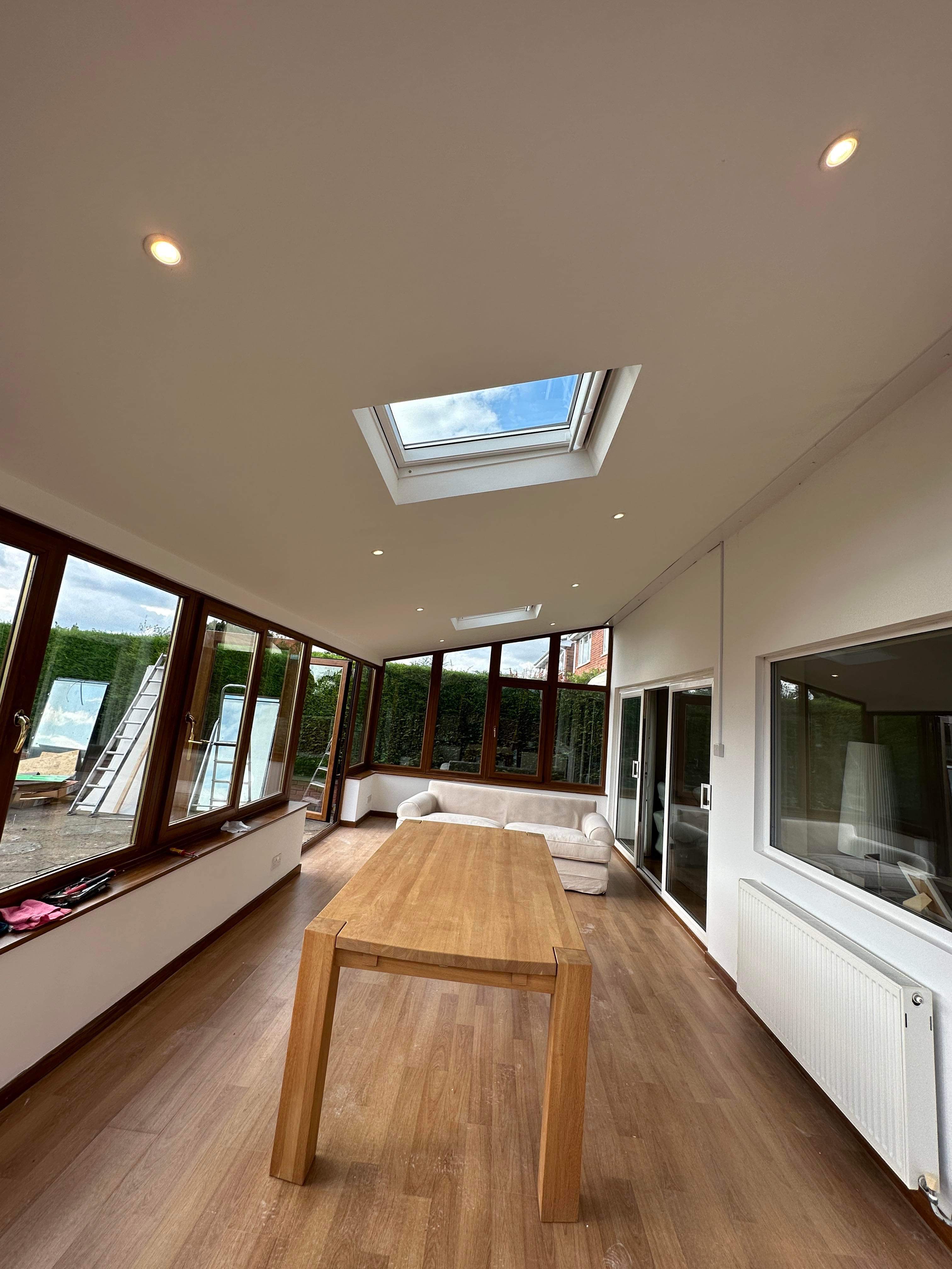 Finished conservatory dining and living area with roof windows