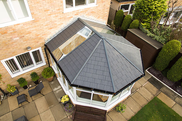 Aerial view of conservatory with dark grey tiled warm roof