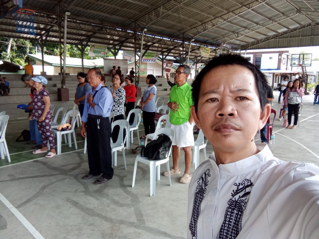 Worship gathering with hands over hearts