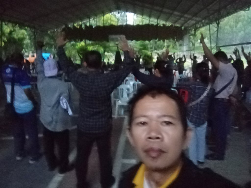 Evening worship with congregation hands raised