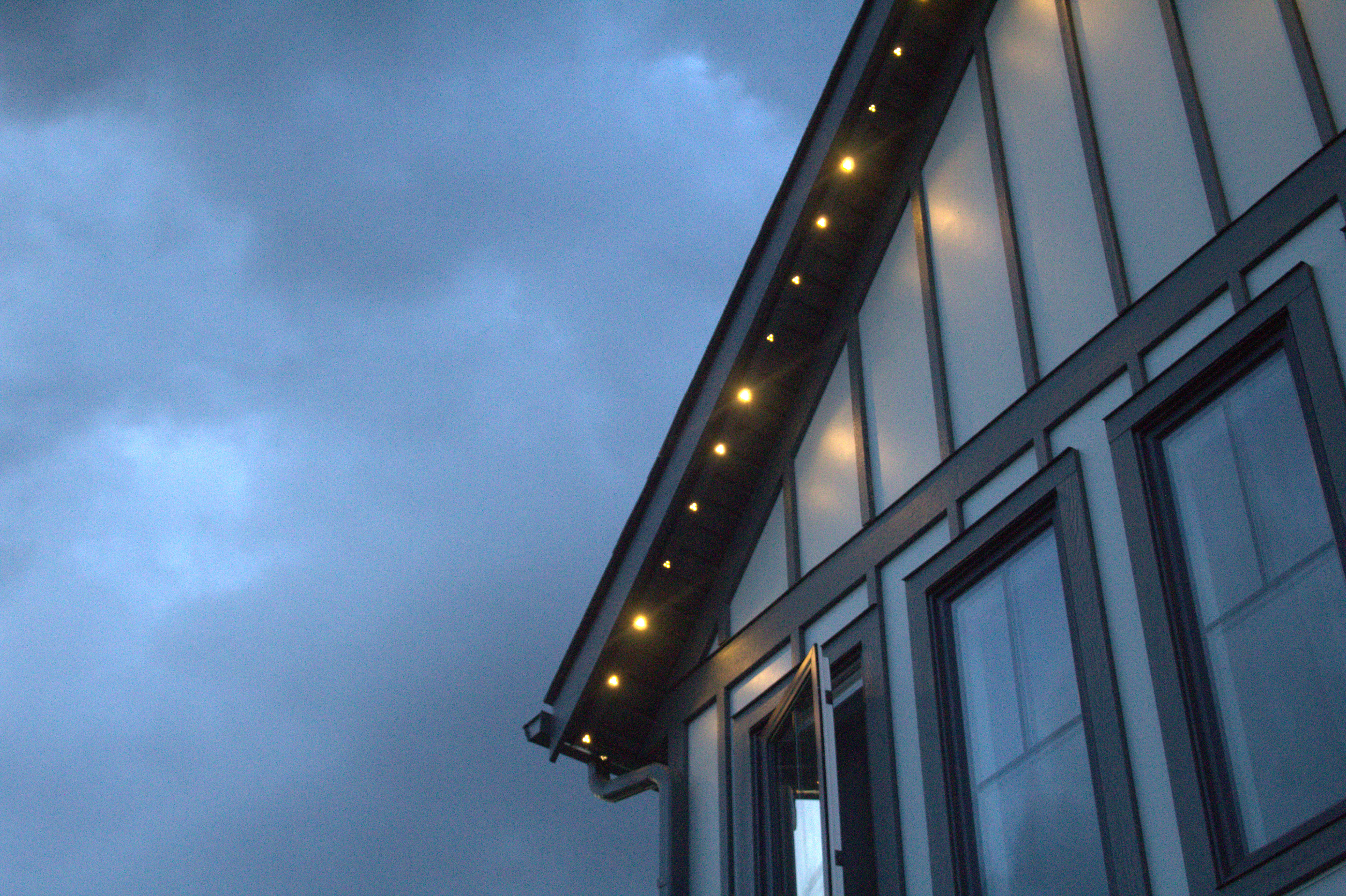 Lit AllStar Lighting LED modules along a roofline at dusk