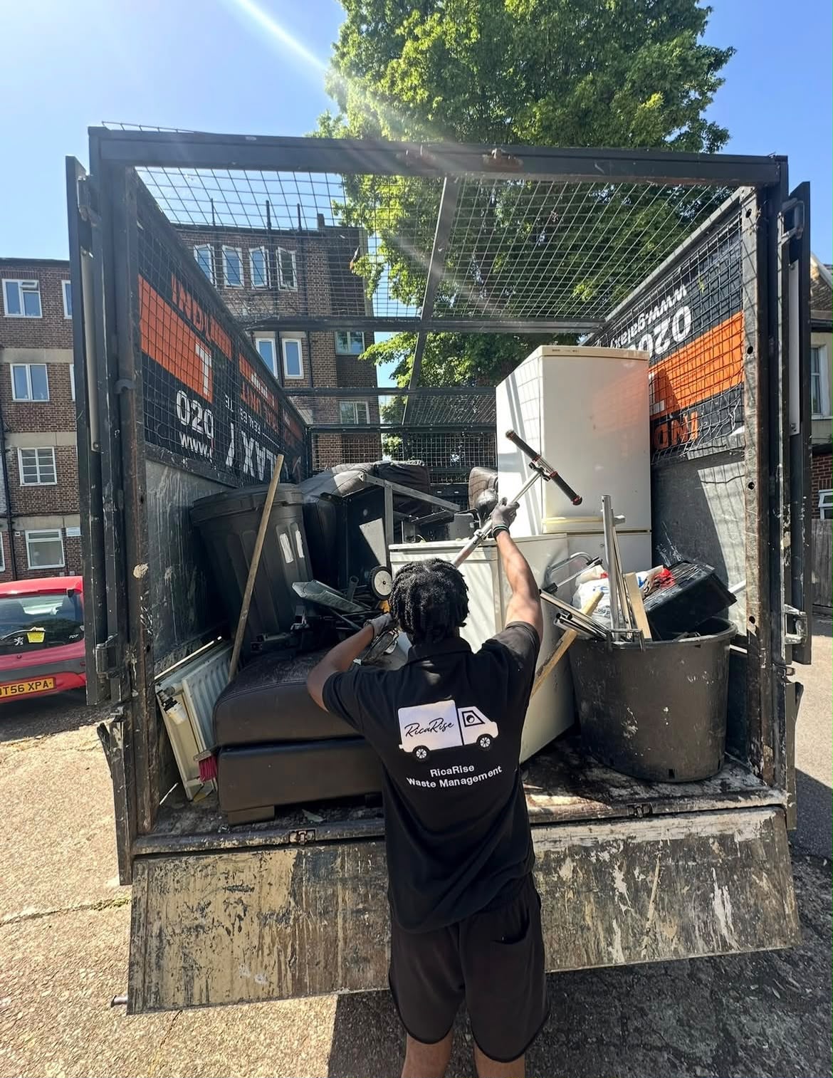 RicaRise Waste Management team loading a full truck load