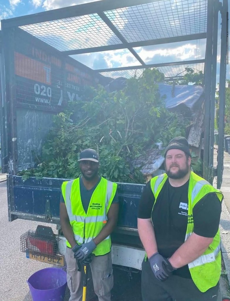 RicaRise team members standing in front of loaded waste removal truck