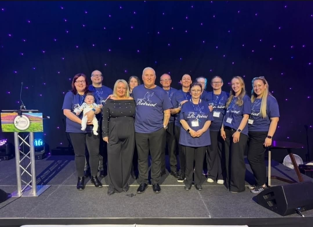 Baby Loss Retreat volunteer team on stage