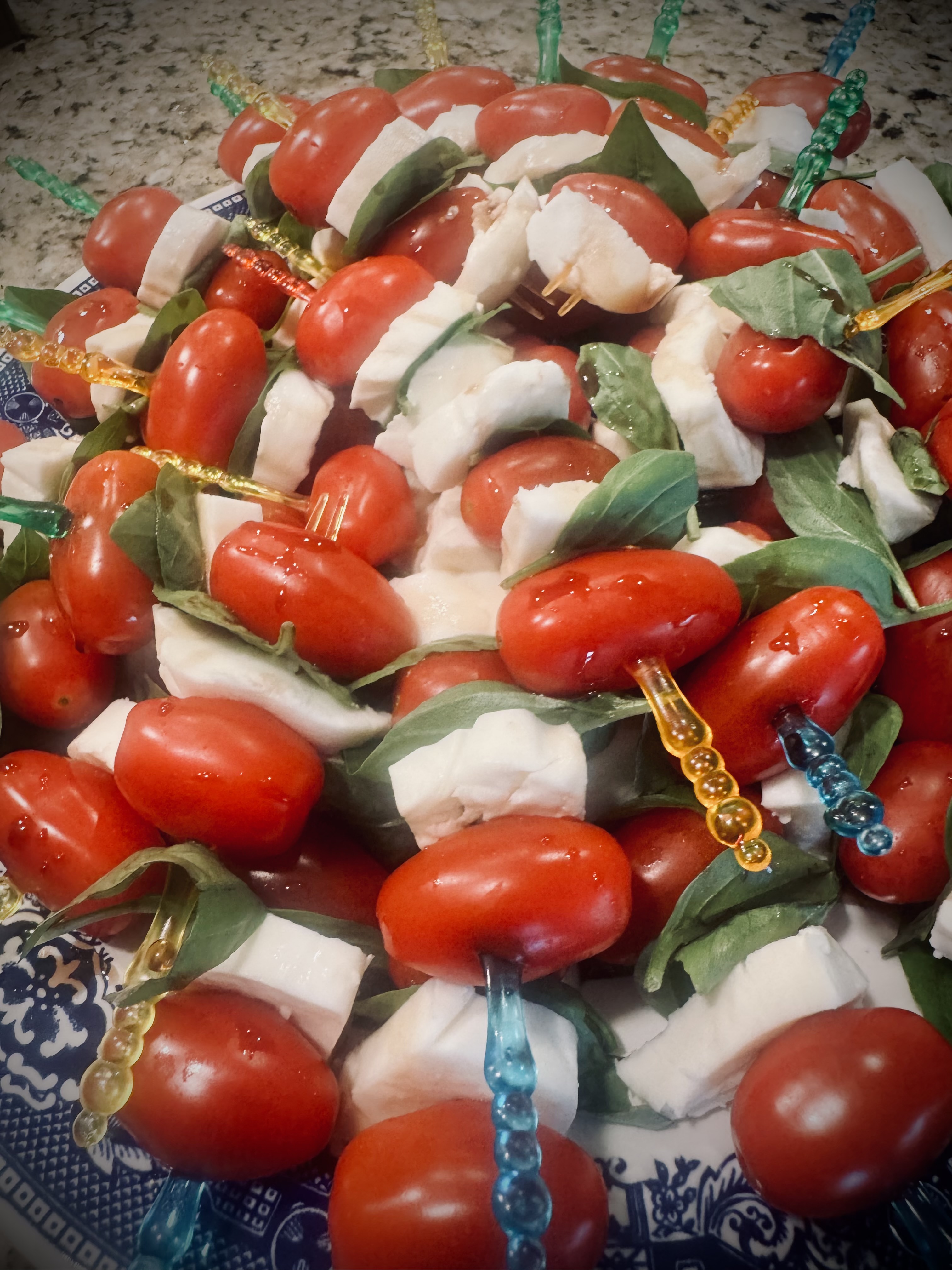Caprese skewers on a blue-and-white patterned platter