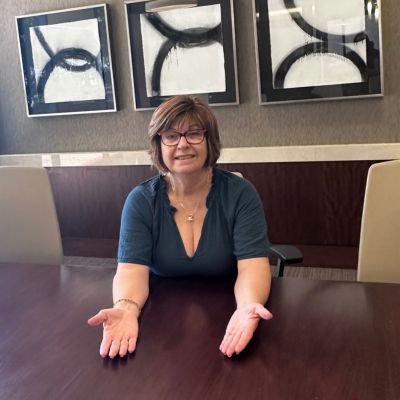 Lynette Sorrentino at the table, inviting you in