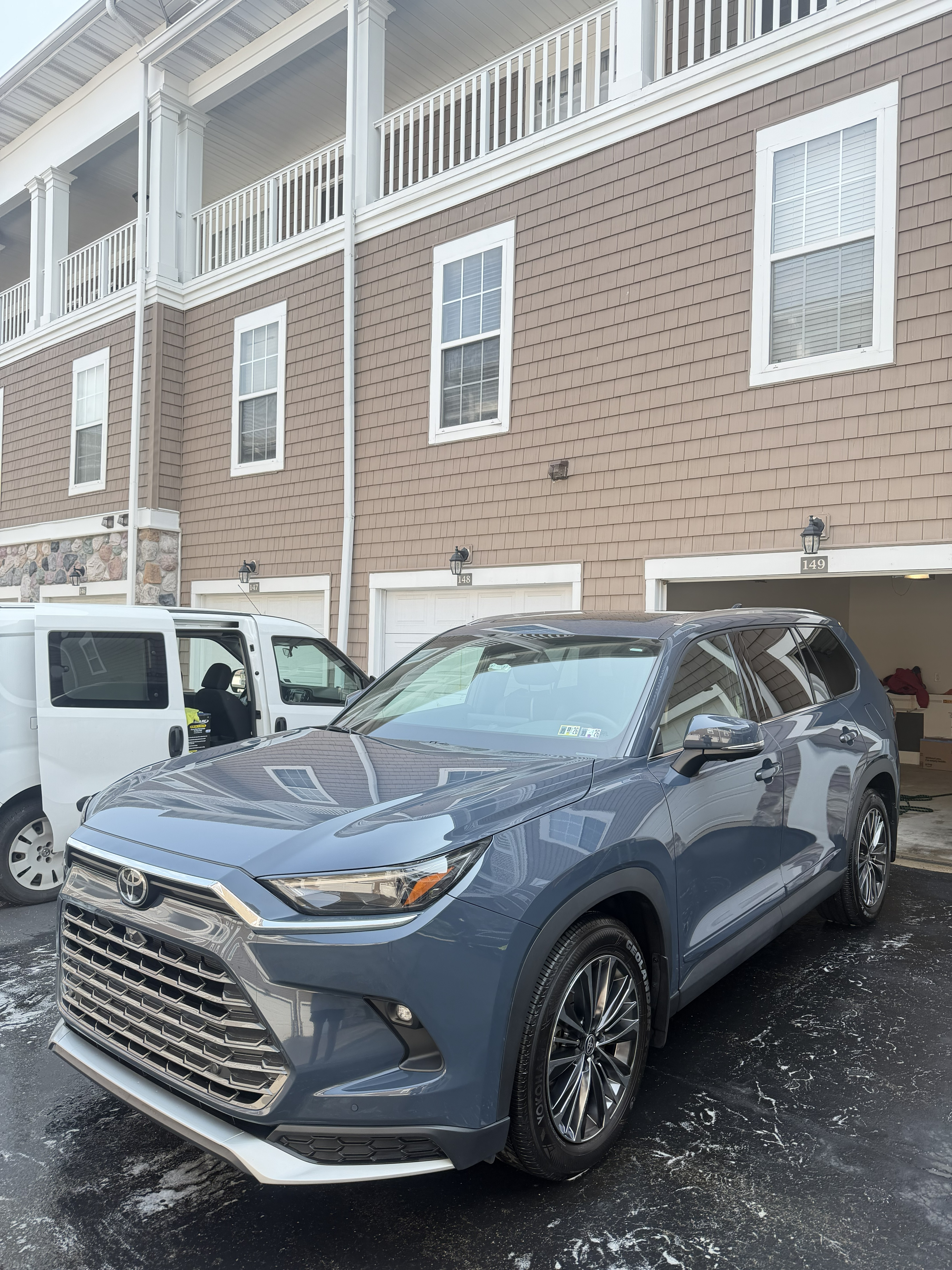 Dark metallic blue Toyota Grand Highlander freshly detailed in a driveway in Fox Chapel, PA