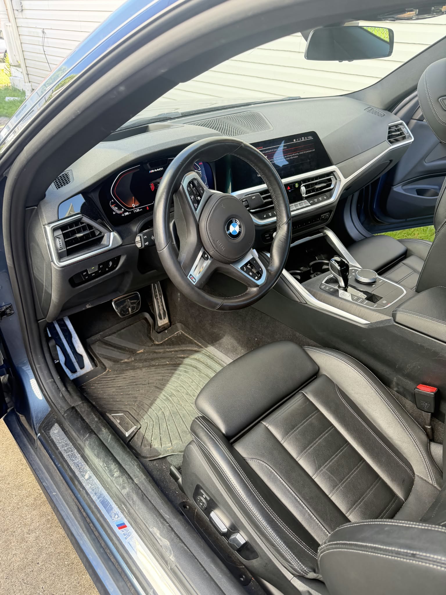 Detailed BMW interior dashboard with digital screen and leather seats