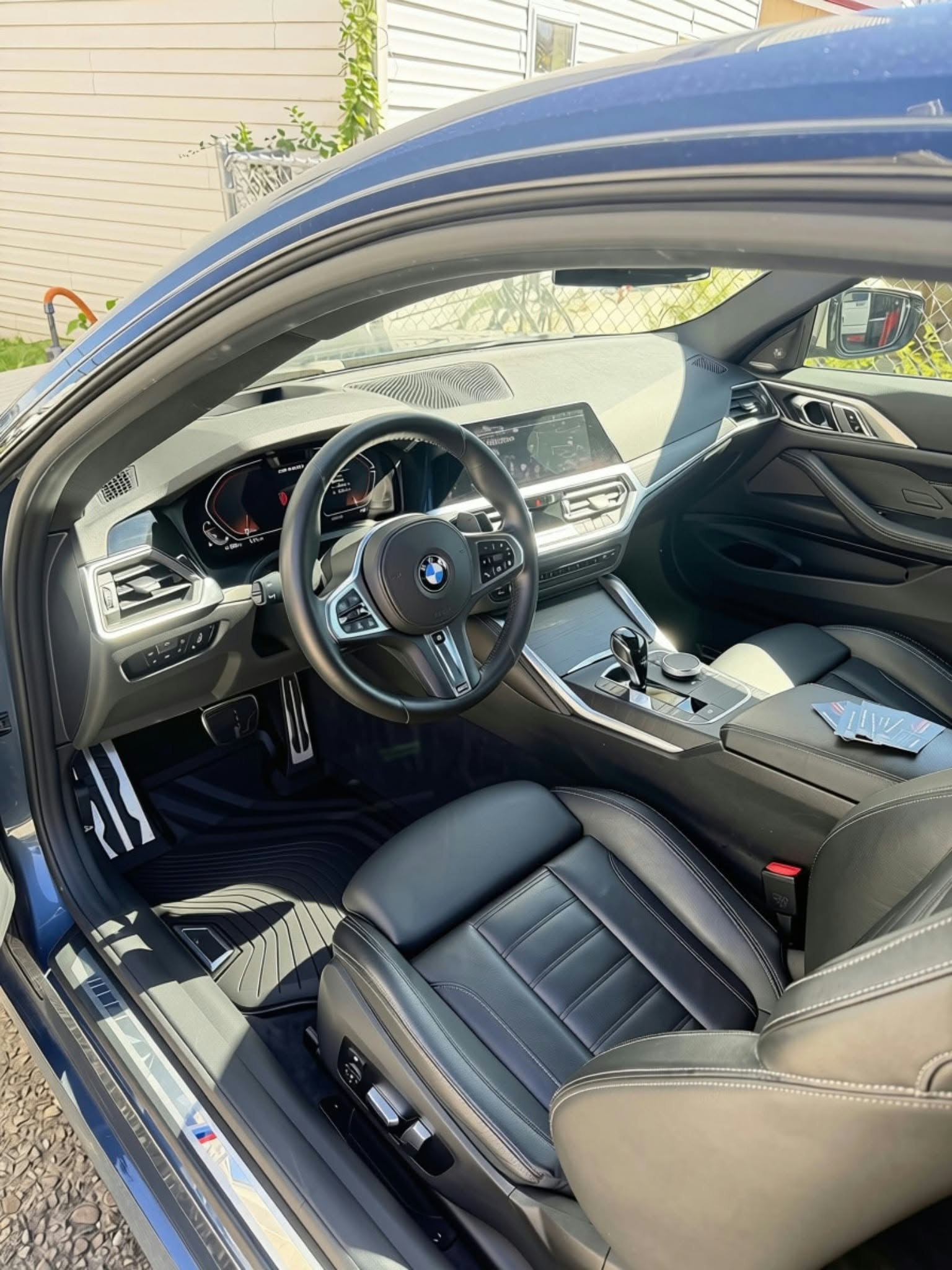 Detailed BMW interior with black leather seats and steering wheel