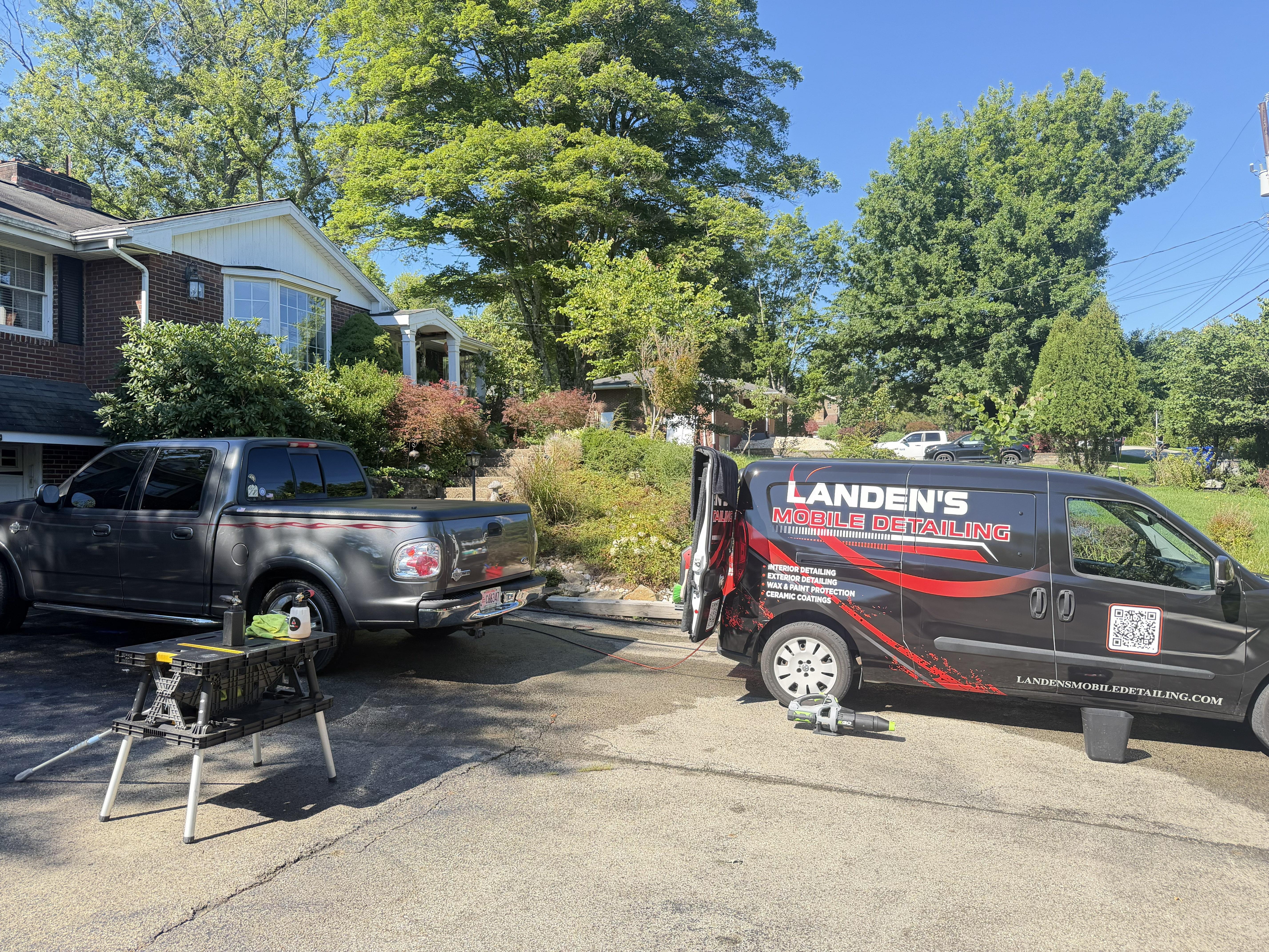 Landen's Mobile Detailing van and mobile setup with a grey pickup truck in a residential driveway in Fox Chapel, PA