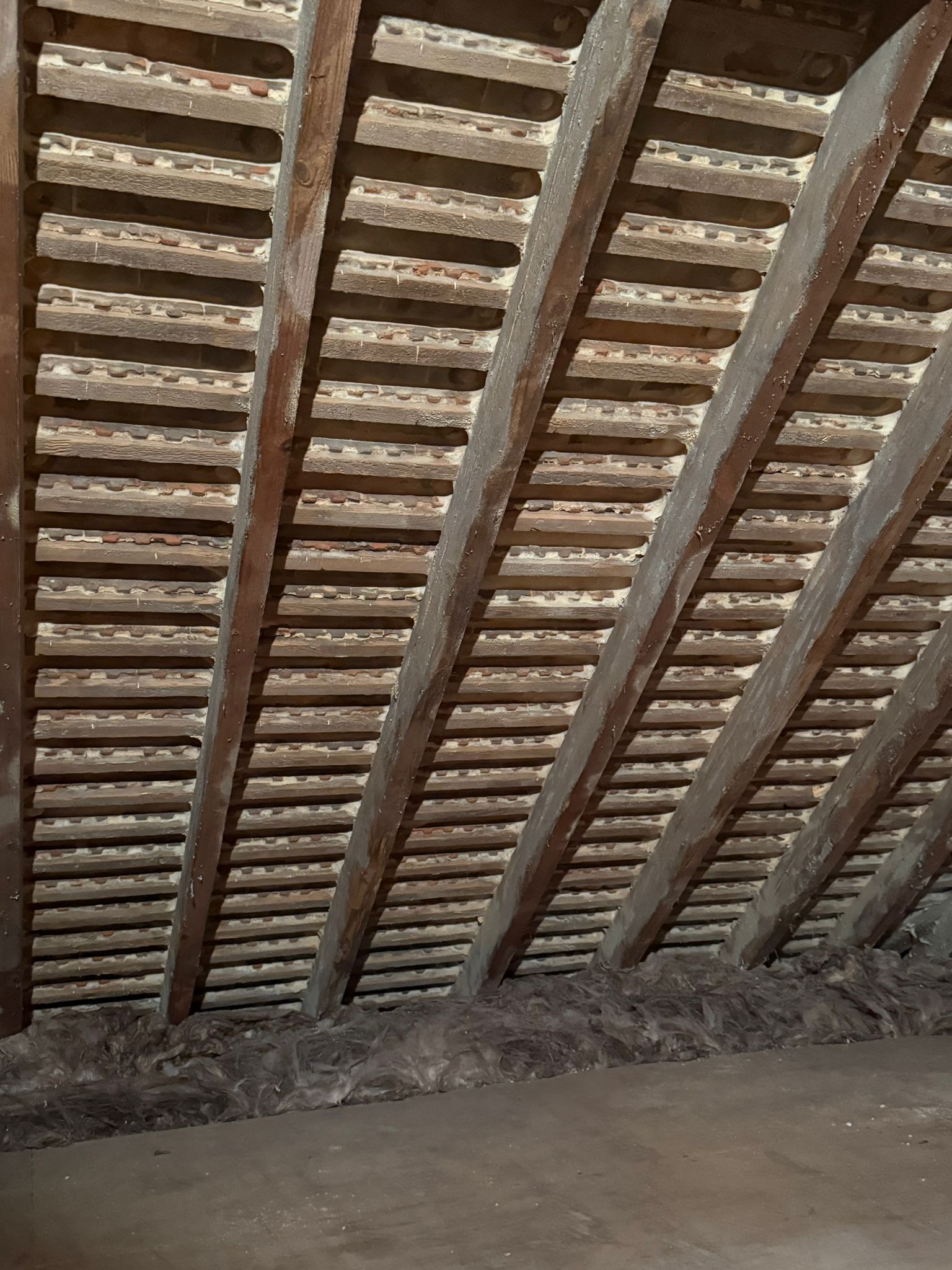 Real Open-Cell Foam spray foam on UK loft timbers — before removal
