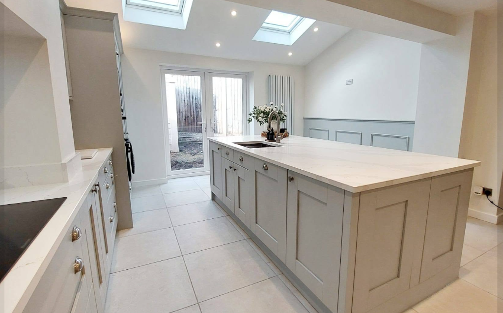 Bespoke grey shaker kitchen with quartz island and vaulted skylights