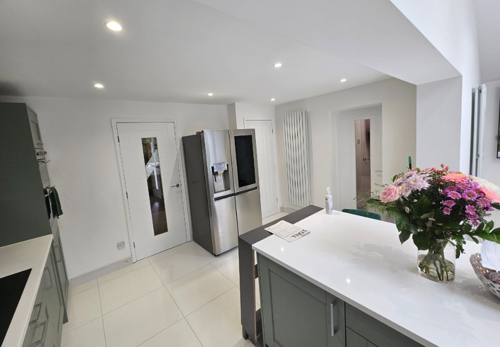 Open plan kitchen extension with grey shaker units and American-style fridge