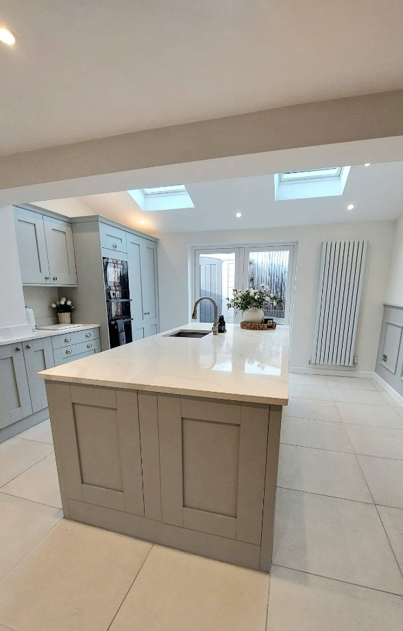 Light open plan kitchen extension with skylights and large island