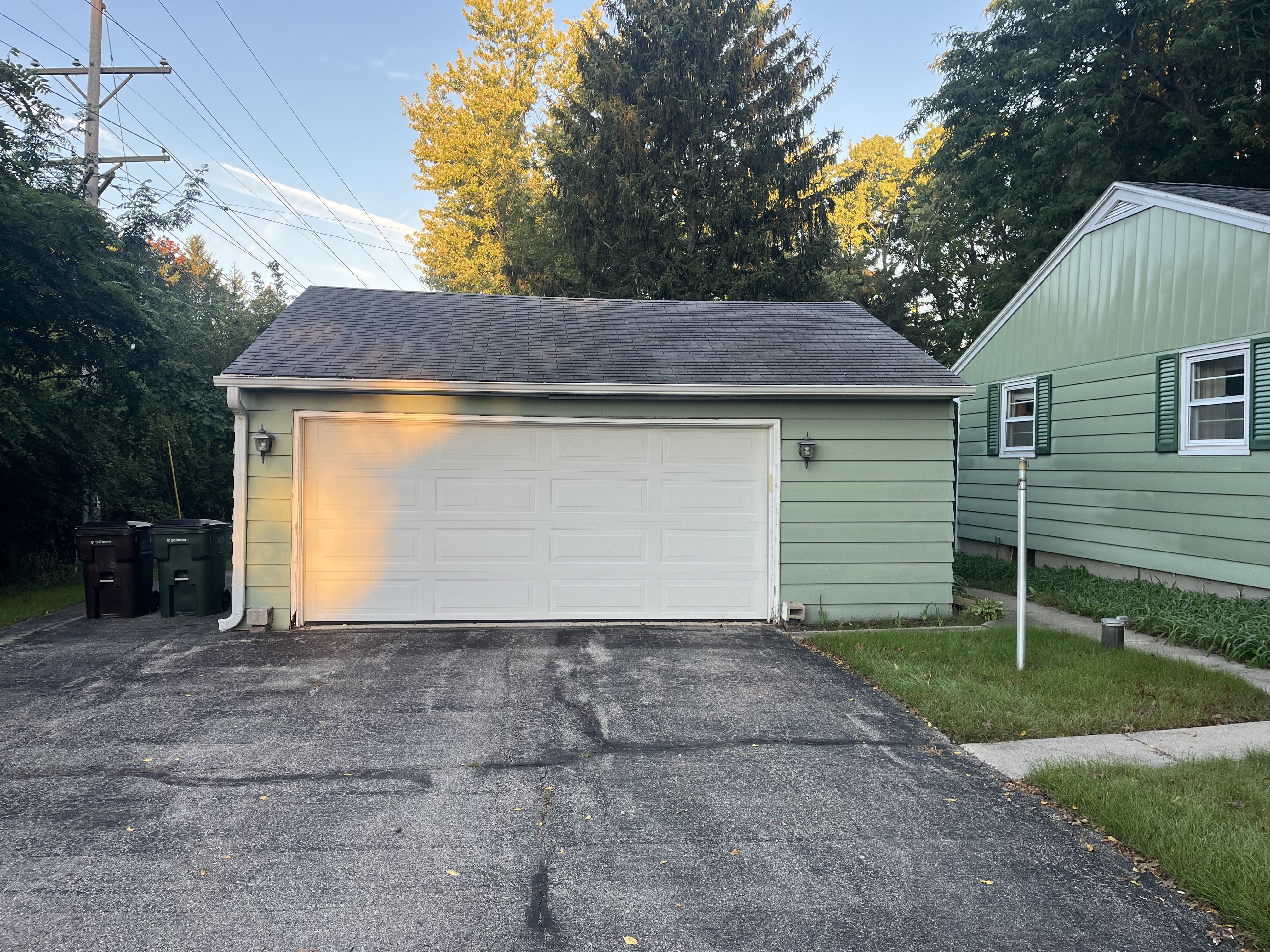 Before — the garage and its aging roof at the start of the project