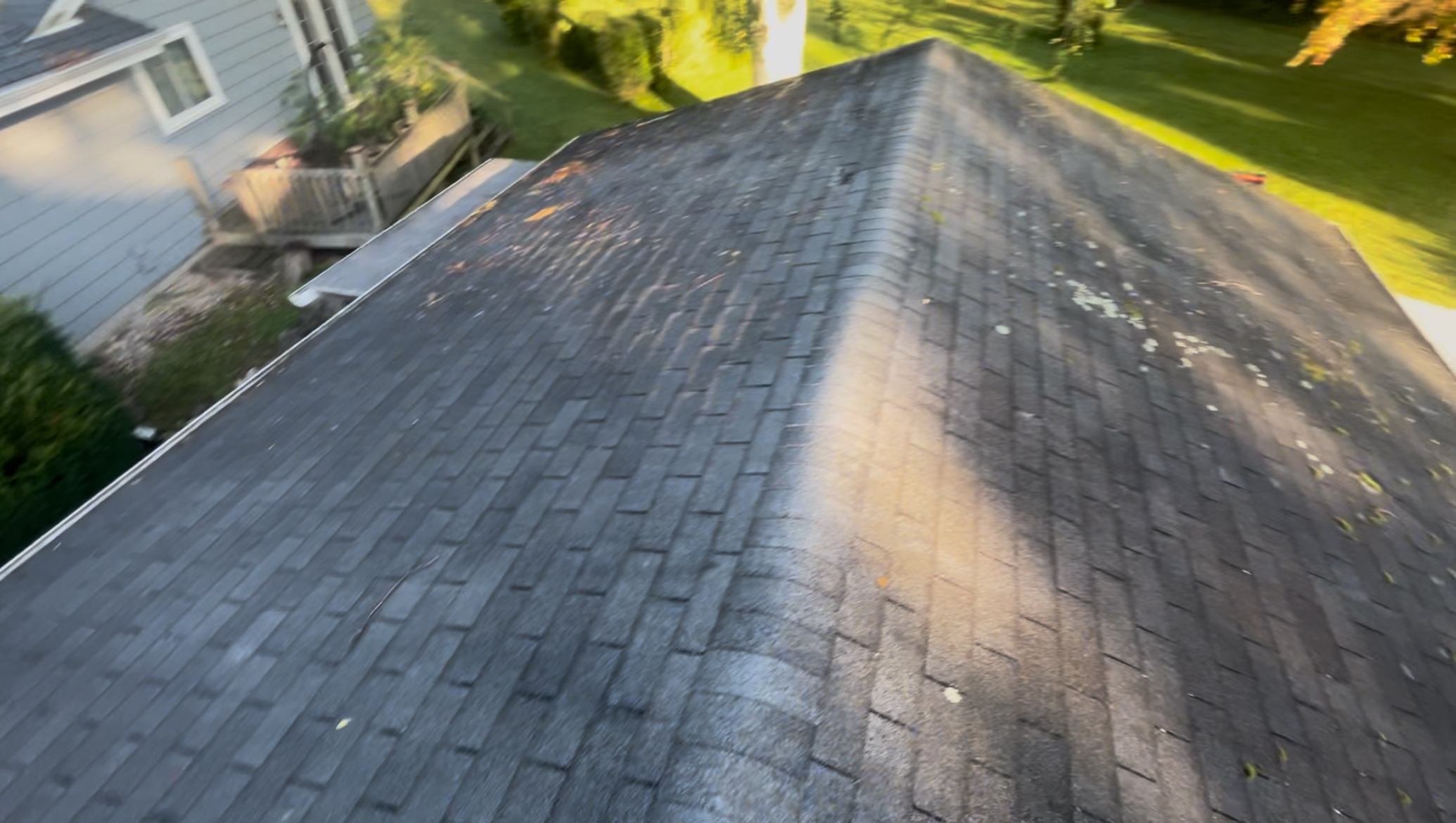 Before — the existing roof, weathered with granule loss and moss growth