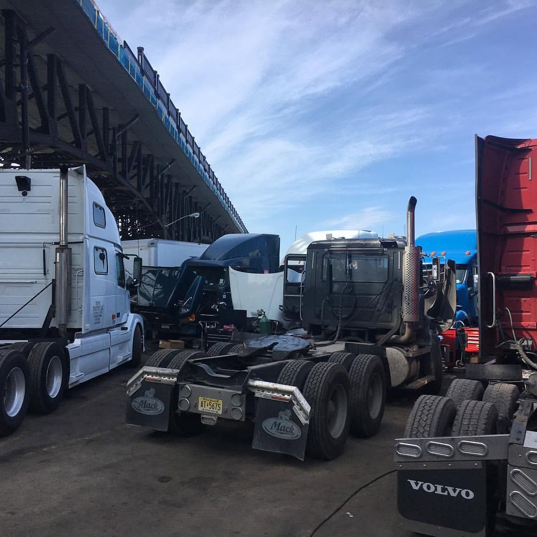 Black Mack day-cab tractor viewed from the rear after service