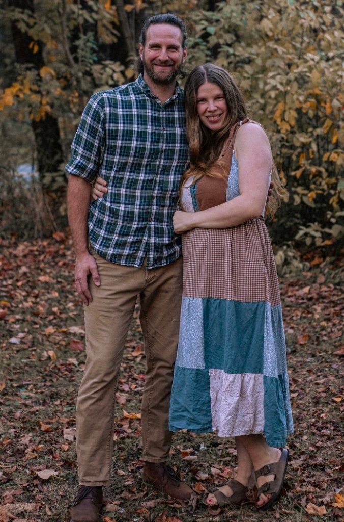 Ryan and Nicole Jenkins standing together outdoors in autumn