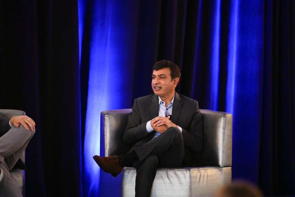 Executive speaking during a panel session at a corporate conference