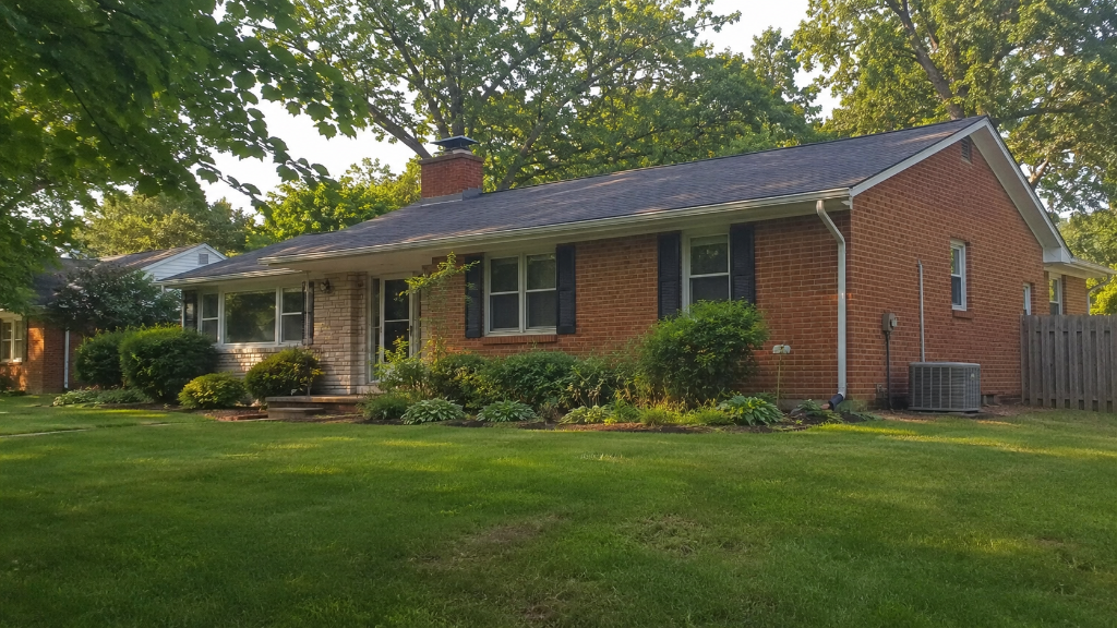 Single-story brick ranch home with an outdoor HVAC condenser unit against the side wall in a Northern Virginia yard
