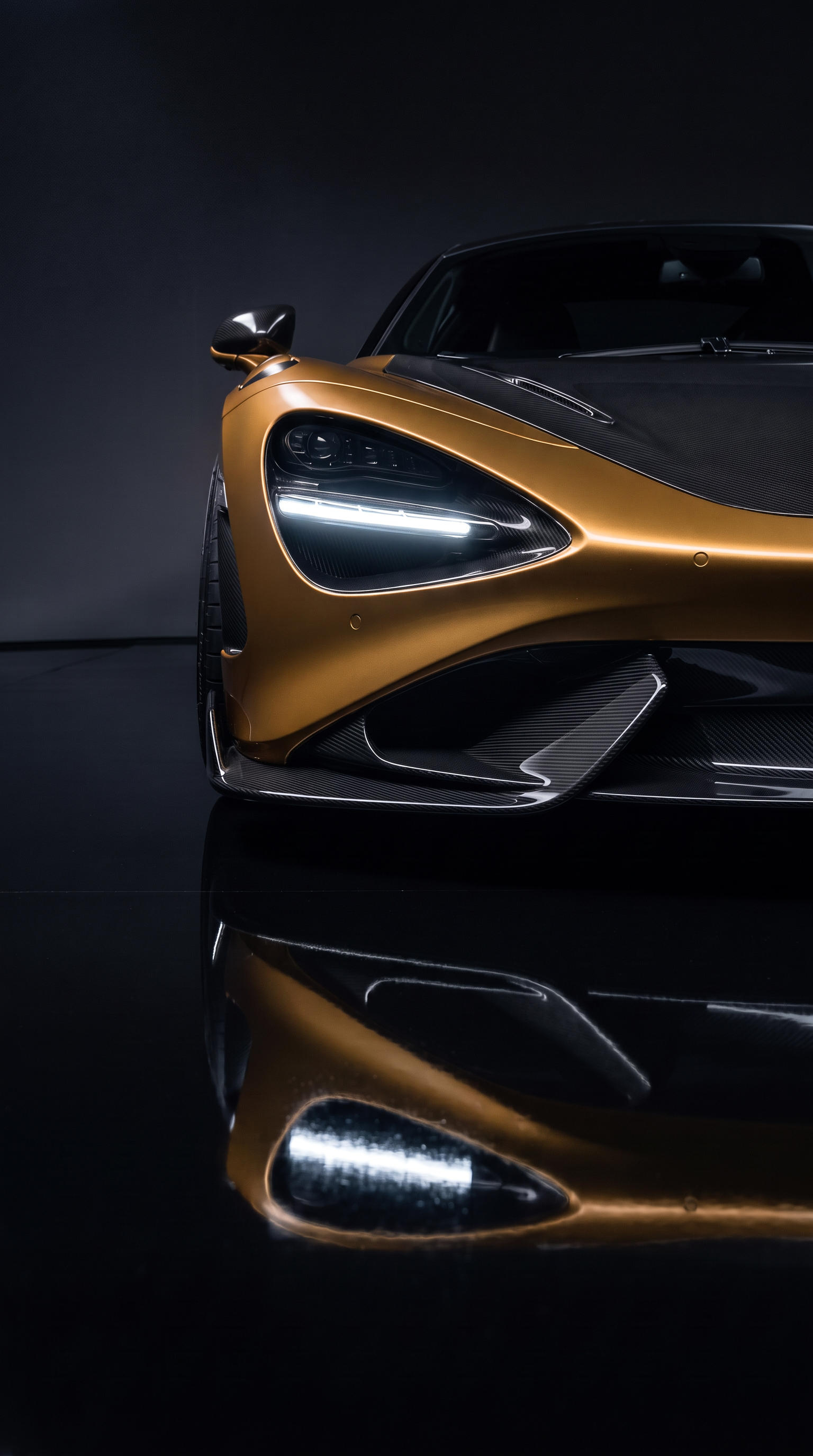 A&A Car Detailing — bronze McLaren 765LT front splitter and carbon fibre detail under dark studio lighting