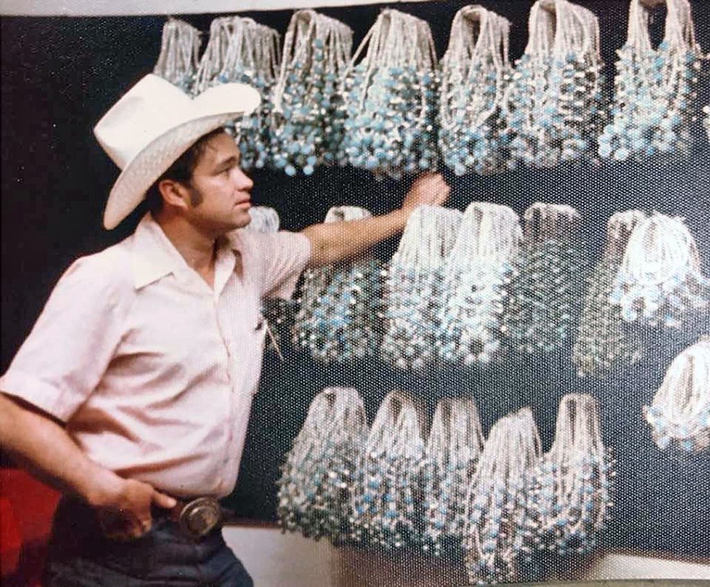 Ralph Maynard displaying handcrafted sterling silver buckles