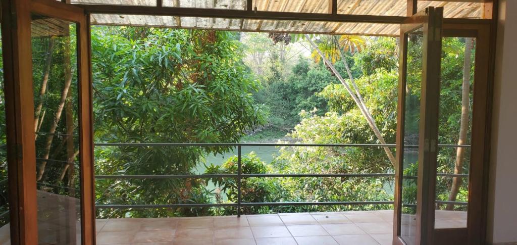 Interior view through open doors to balcony and forest