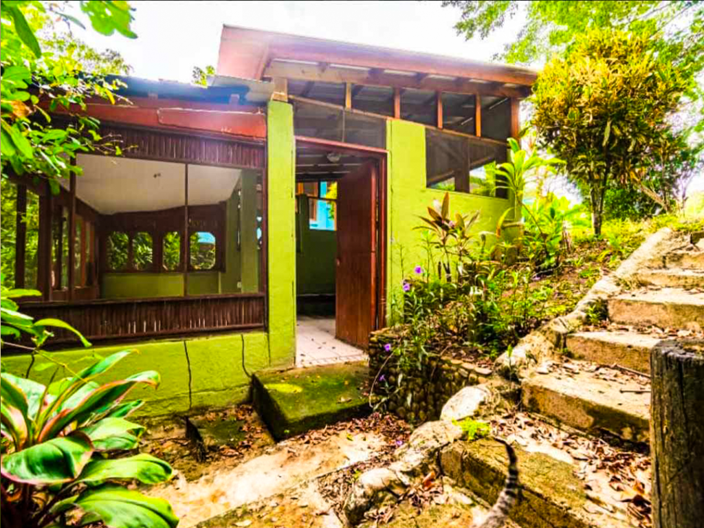Cabin exterior with screened windows and stone staircase