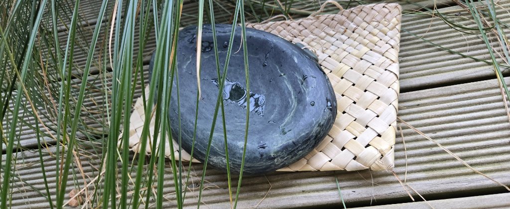Carved stone on woven mat