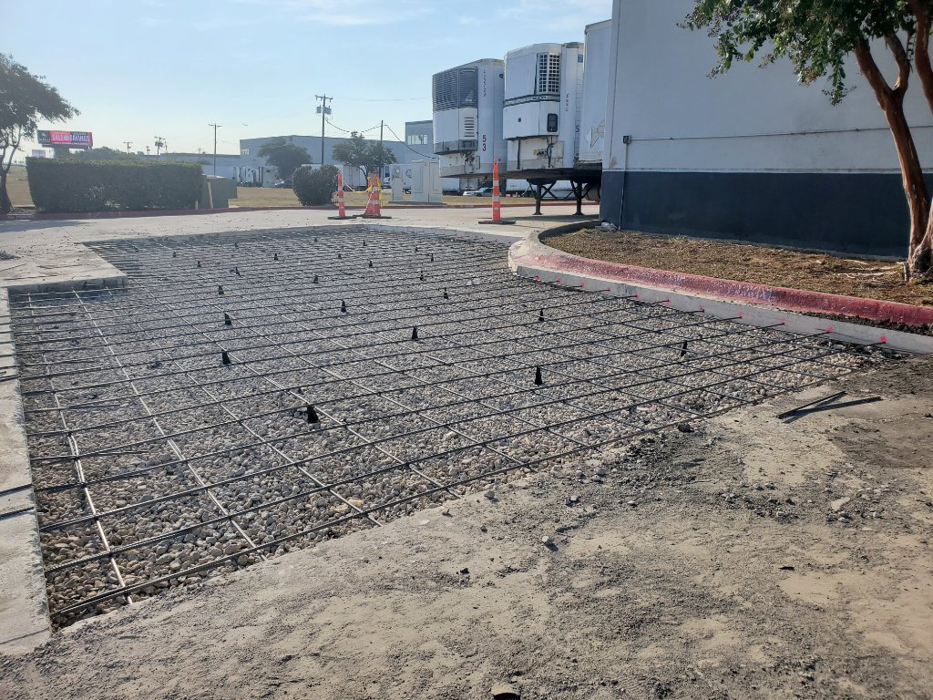 Crew finishing residential concrete driveway