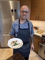 Chef Charles Bell holding a plated dish