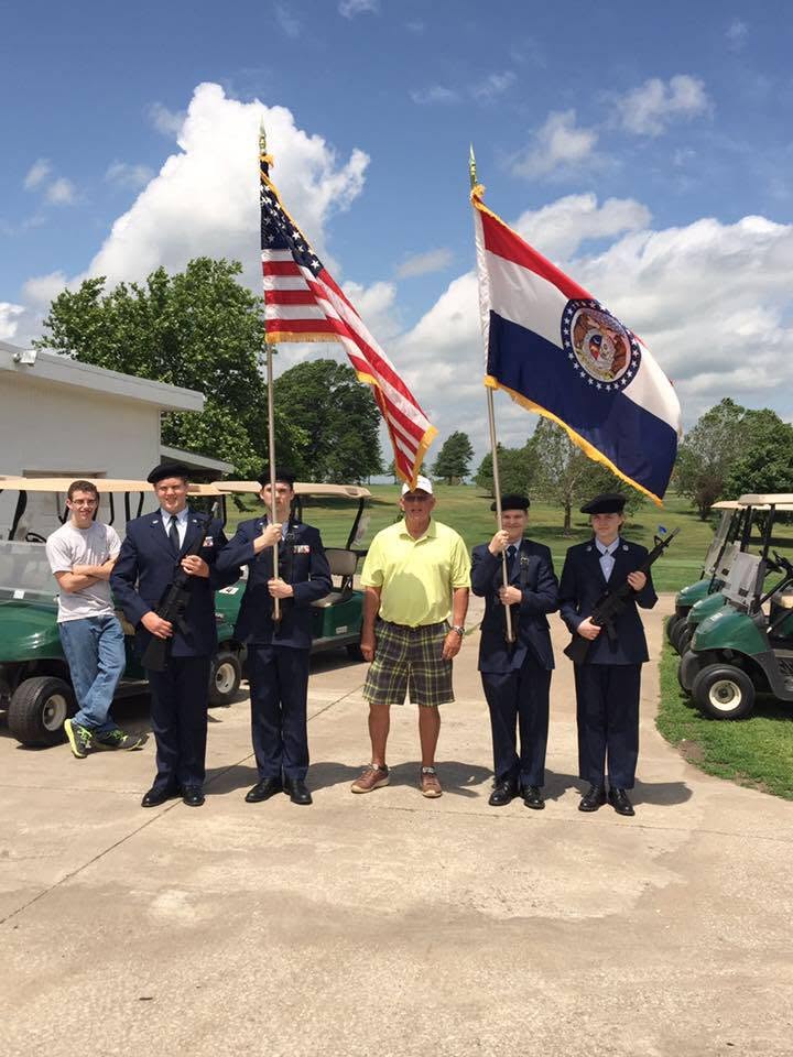 Dr. McClendon with Missouri and USA flags honor guard
