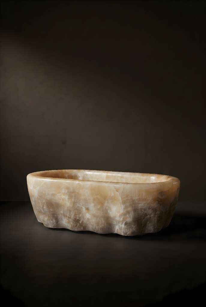 Low warm onyx trough bathtub, hand-carved and footed