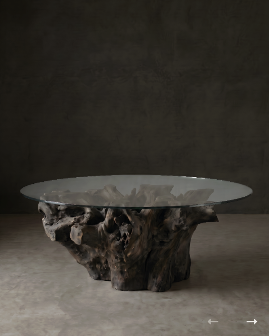 Round glass-topped coffee table with a sculptural natural wood root base