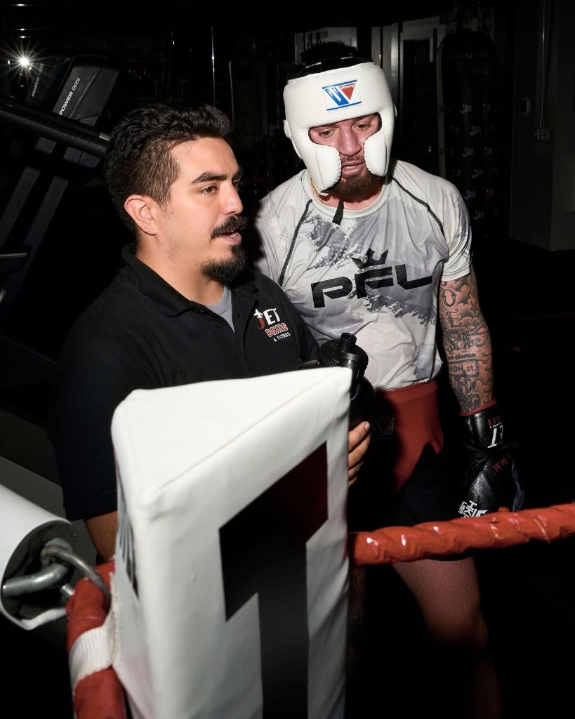 Coach Joe working with a boxer in the ring