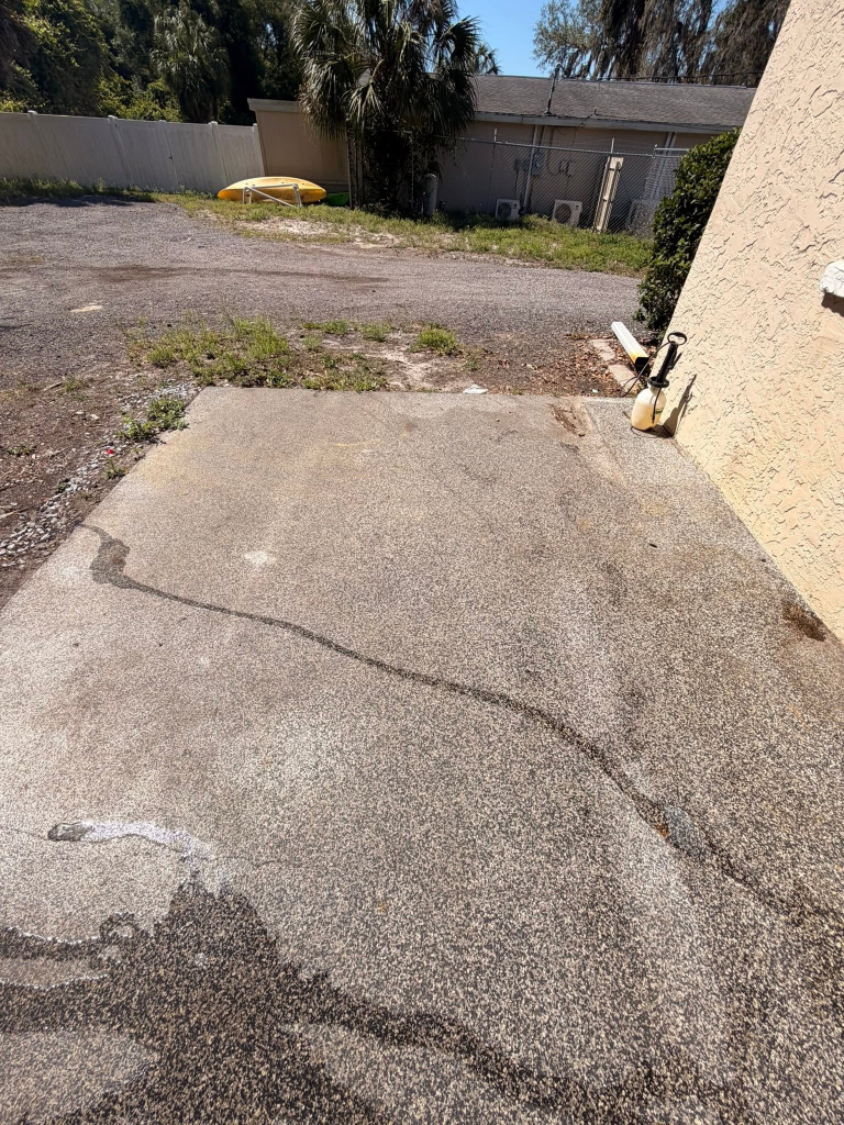 Before: Pressure washing in Homosassa FL - weathered concrete patio cleaned and restored