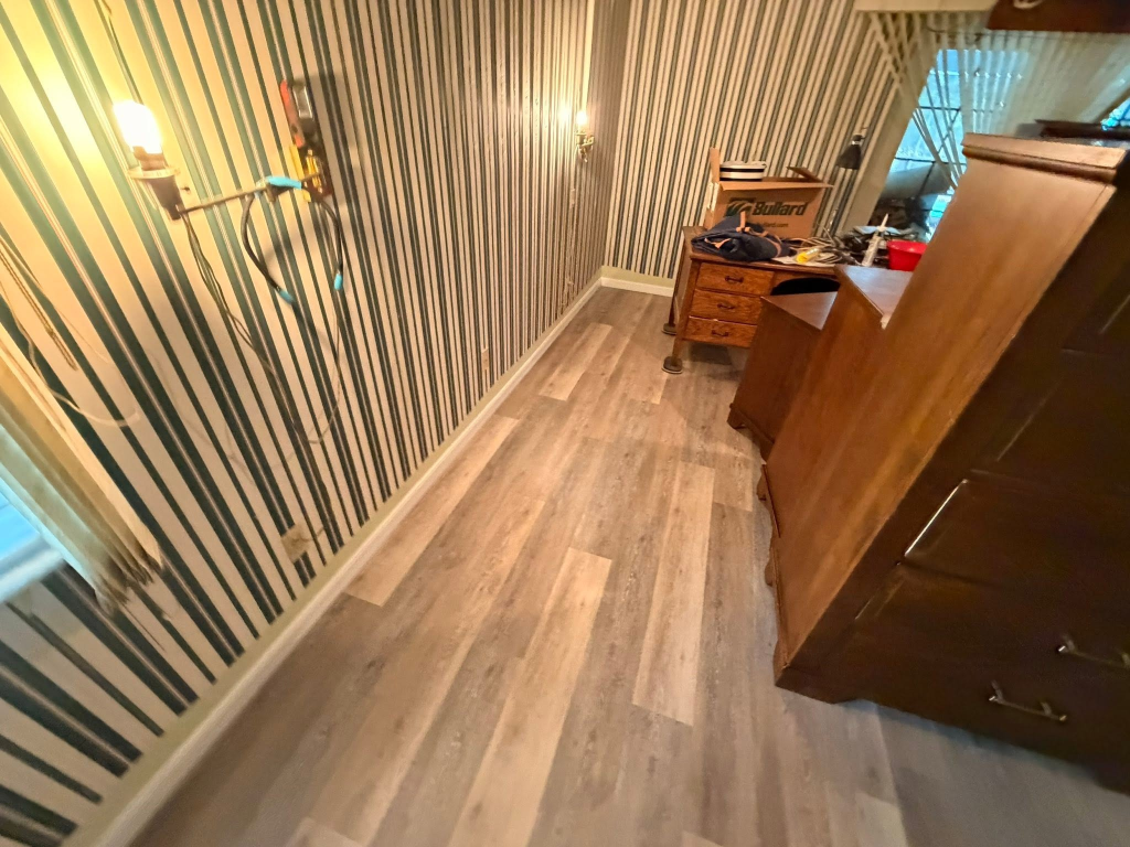 After: Bedroom flooring renovation in Beverly Hills FL - old green carpet removed and replaced with luxury vinyl plank