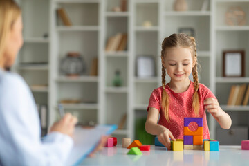 Child engaged in therapeutic educational assessment with professional