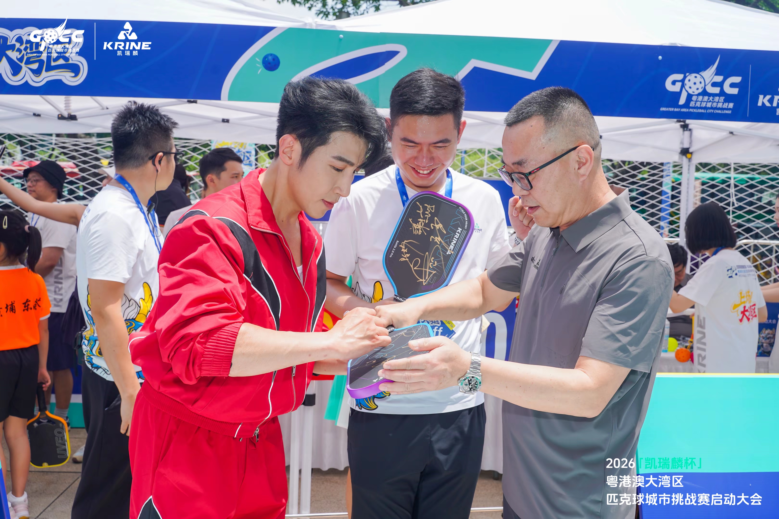 Autograph signing on a pickleball paddle at the launch event