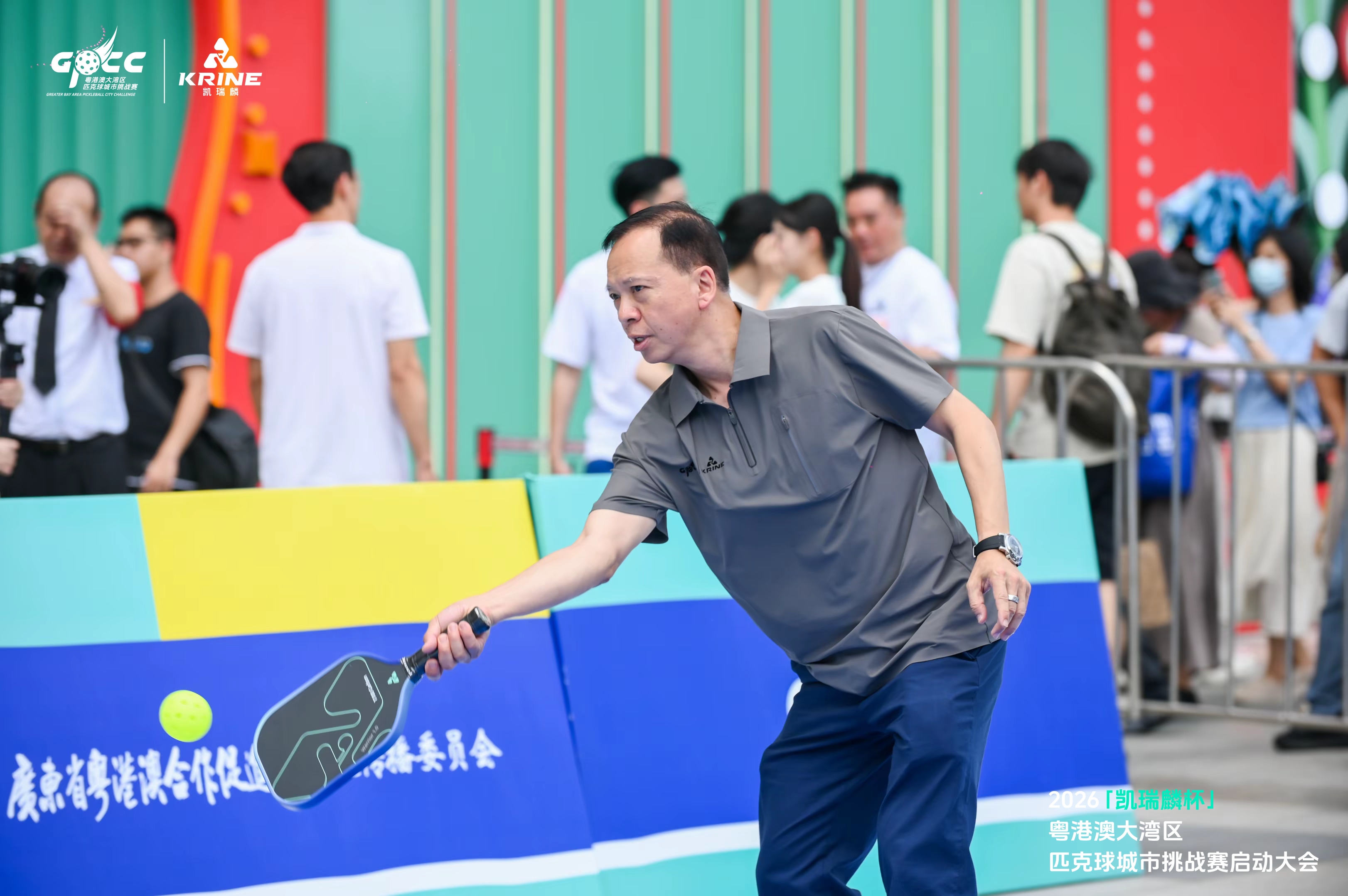 Player mid-forehand stroke with a pickleball in flight