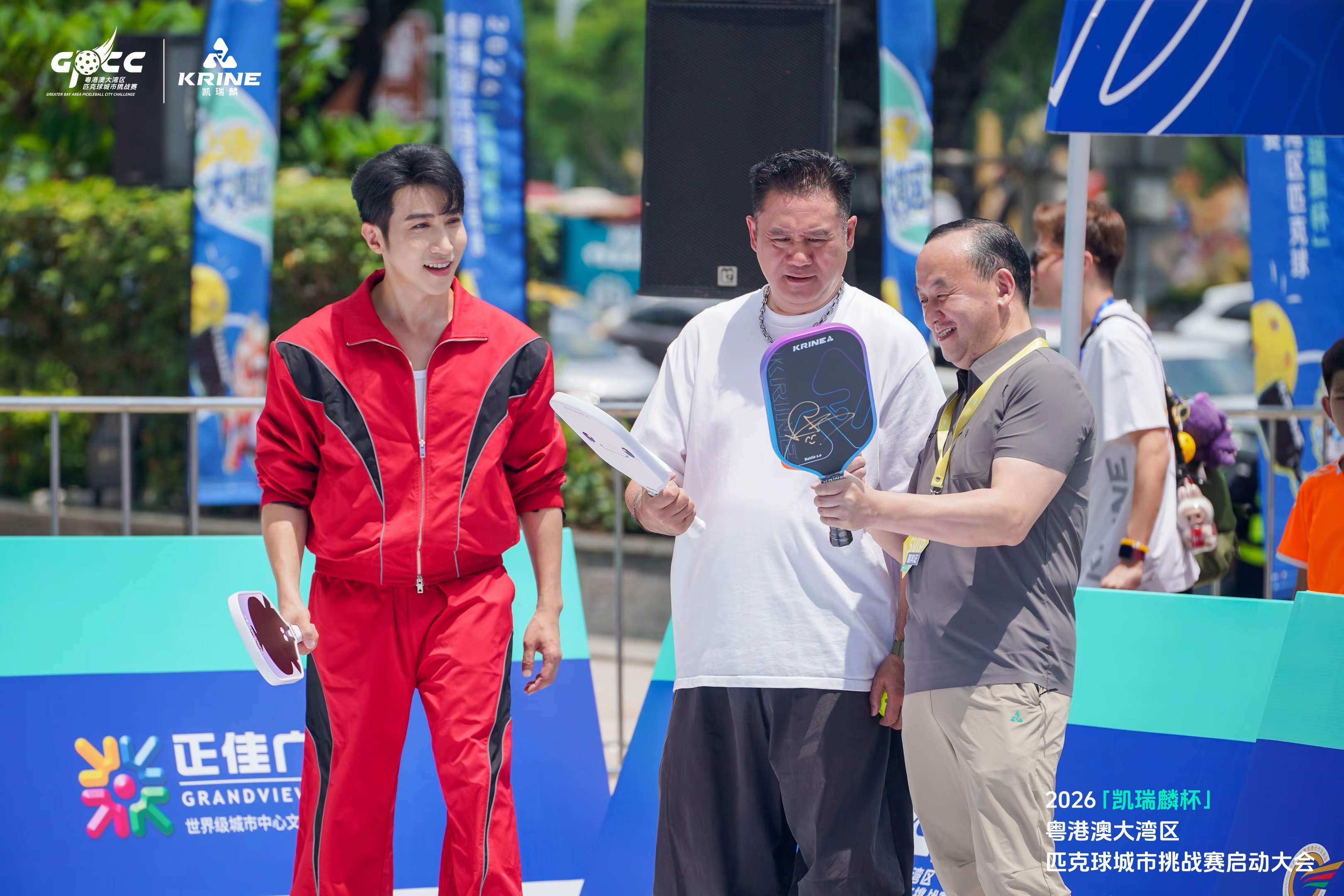 Guests inspecting a signed pickleball paddle at the launch event