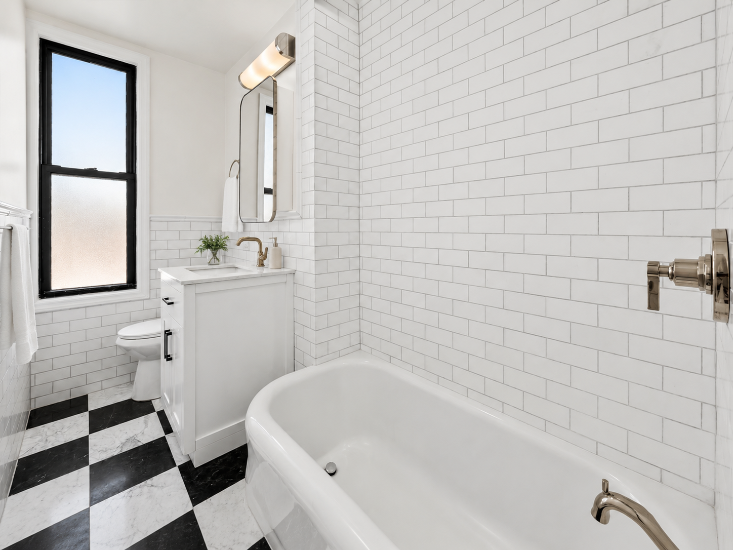 White oak vanity with marble top, glass walk-in shower with marble mosaic, and black-and-white checkerboard marble floor